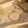 Διπλό βραχιόλι με celestial charms αστέρια φεγγάρι και τιρκουάζ ζιργκόν, χρυσό ανοξείδωτο ατσάλι, flat lay σε σατέν — Celestial Steel