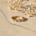 Δαχτυλίδι open band με cushion-cut και pear-cut ζιργκόν, χρυσό ανοξείδωτο ατσάλι, flat lay σε μάρμαρο — Celestial Steel