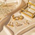 Set 3 σκουλαρικιών huggie, heart stud και marquise climber, χρυσό ανοξείδωτο ατσάλι, flat lay με κοσμηματοθήκη — Celestial Steel