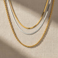Τριπλό κολιέ αλυσίδα herringbone και rope σε χρυσό και ασημί, flat lay — Celestial Steel