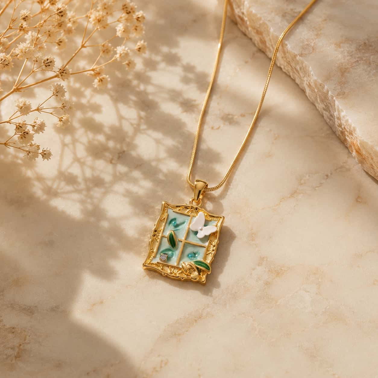Κολιέ enamel pendant παράθυρο με πεταλούδα σε snake chain, lifestyle με μάρμαρο, βιβλίο και gypsophila — Celestial Steel
